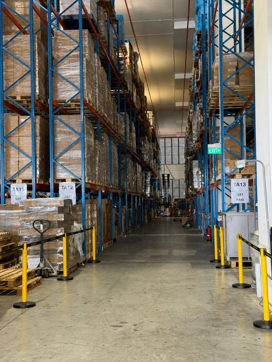 Warehouse aisle with pallet racking and stored inventory